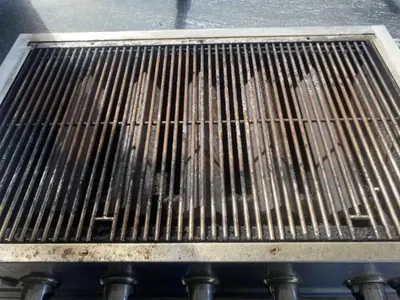 The same BBQ grates before cleaning: rusted and coated in carbon