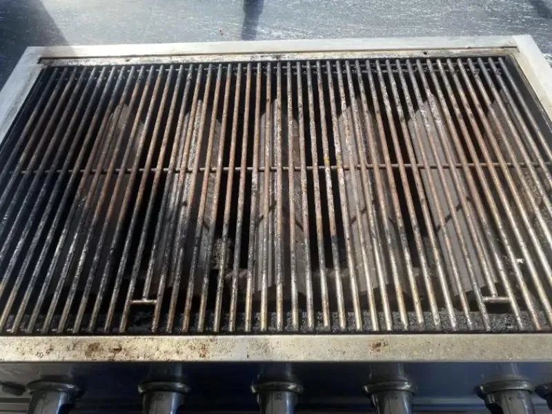 Built-in gas grill before cleaning: rusted, grease-coated grates